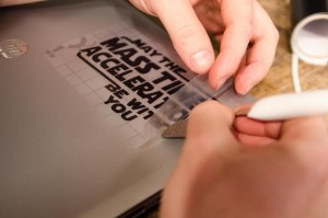 Peeling the transfer tape from vinyl on the back of the laptop   